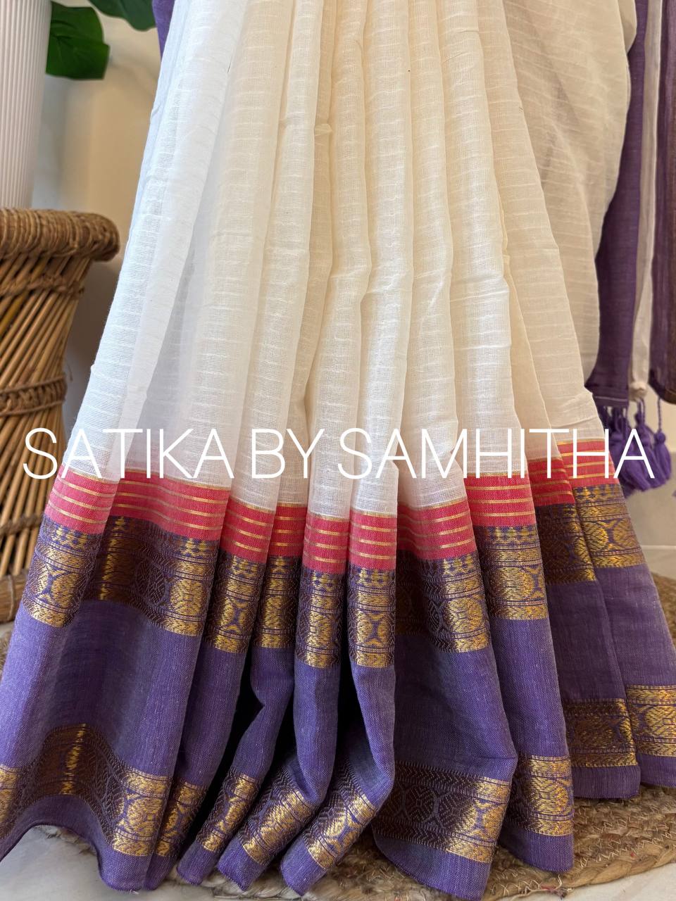 STSC35 - Pure 120 count Mulcotton Saree, subtly textured off-white body, striking lavender kanchi border, coral pink accent lines along with golden zeri stripes, Ready to dispatch