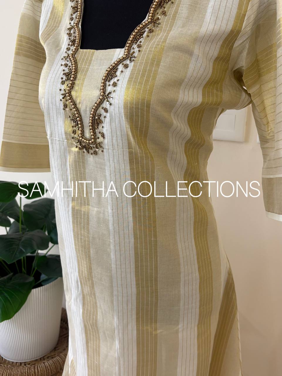 SC3295 - Kerala Tissue kurtis with allover kasavu stripes highlighted with intricately handworked neckline and small puff sleeves