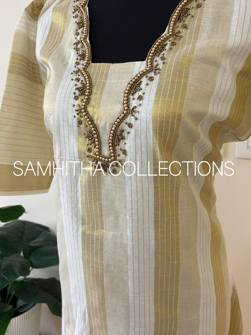 SC3295 - Kerala Tissue kurtis with allover kasavu stripes highlighted with intricately handworked neckline and small puff sleeves